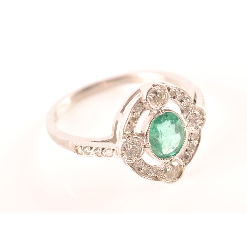 30 - An emerald, diamond and platinum ring, set with an oval old cut emerald with an approximate weight o... 