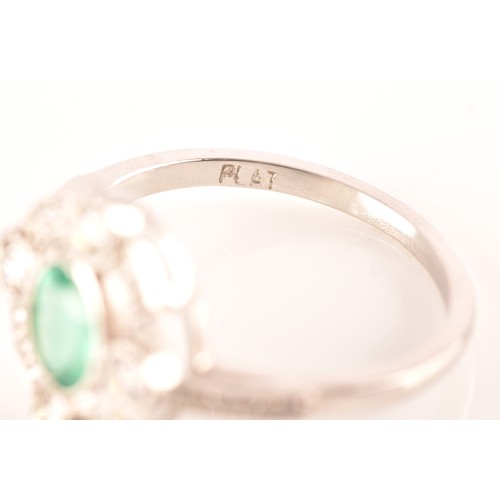 30 - An emerald, diamond and platinum ring, set with an oval old cut emerald with an approximate weight o... 