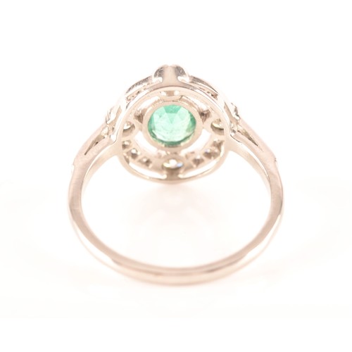 30 - An emerald, diamond and platinum ring, set with an oval old cut emerald with an approximate weight o... 