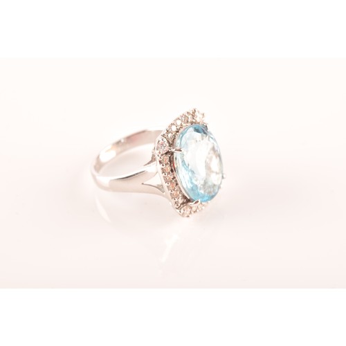 31 - A platinum cluster ring, set to centre with an oval aquamarine with an approximate weight of 7.60 ca... 