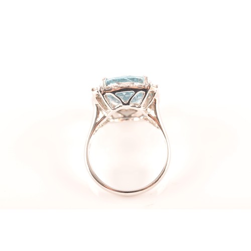 31 - A platinum cluster ring, set to centre with an oval aquamarine with an approximate weight of 7.60 ca... 