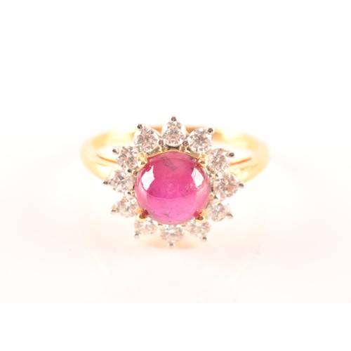 32 - A 18ct yellow gold cabochon ruby cluster ring, set with a central Burmese round cabochon ruby with a... 