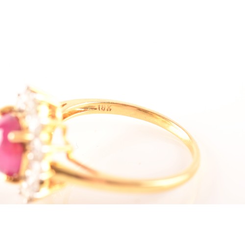 32 - A 18ct yellow gold cabochon ruby cluster ring, set with a central Burmese round cabochon ruby with a... 