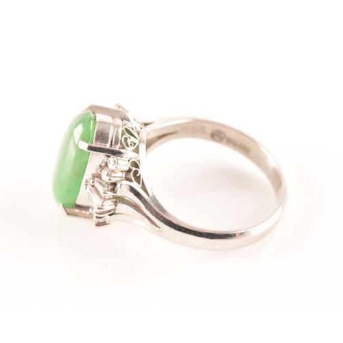 33 - A platinum ring set to centre with an elongated oval cabochon jade measuring approximately 14 x 7.2 ... 