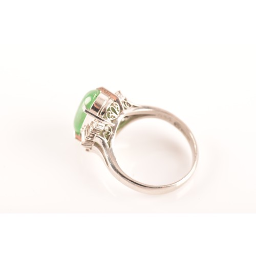 33 - A platinum ring set to centre with an elongated oval cabochon jade measuring approximately 14 x 7.2 ... 