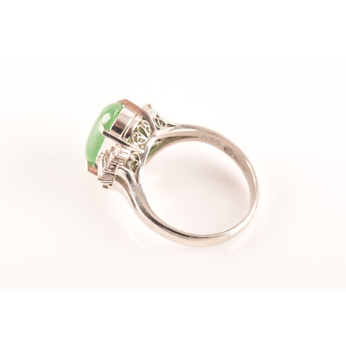 33 - A platinum ring set to centre with an elongated oval cabochon jade measuring approximately 14 x 7.2 ... 