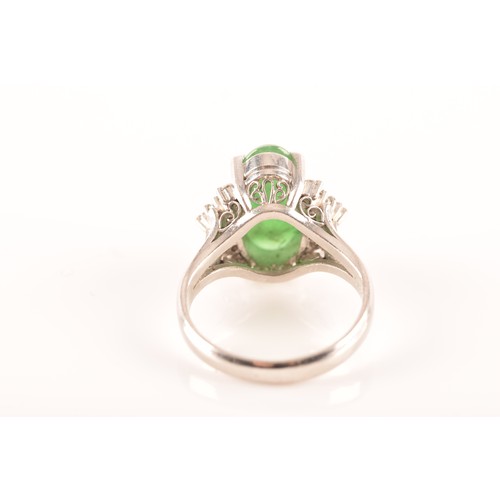 33 - A platinum ring set to centre with an elongated oval cabochon jade measuring approximately 14 x 7.2 ... 