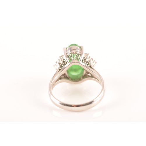 33 - A platinum ring set to centre with an elongated oval cabochon jade measuring approximately 14 x 7.2 ... 