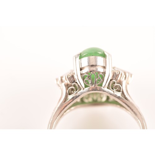 33 - A platinum ring set to centre with an elongated oval cabochon jade measuring approximately 14 x 7.2 ... 