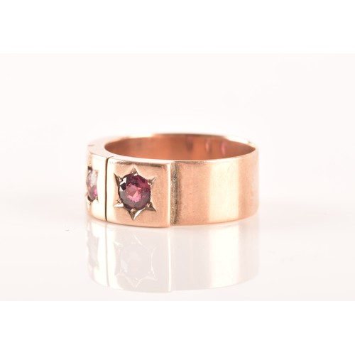 34 - A 9ct rose gold gypsy ring, featuring three almandine garnets with an approximate weight of 0.30 car... 