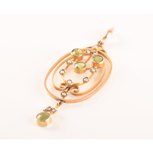 97 - An Edwardian yellow metal, peridot, and split seed pearl pendant, in the Art Nouveau taste, the oval... 