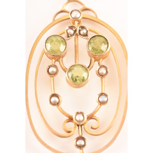 97 - An Edwardian yellow metal, peridot, and split seed pearl pendant, in the Art Nouveau taste, the oval... 