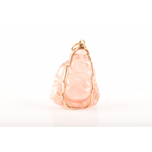 84 - A yellow metal mounted rose quartz Buddha pendant, unmarked, together with a 9ct yellow gold and ame... 