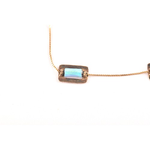 85 - A 9ct yellow gold and opal necklace, set with six rolled opal beads each in a rectangular gold mount... 