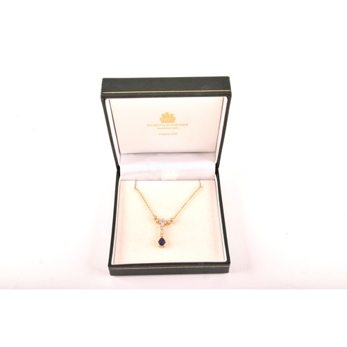 93 - An 18ct yellow gold sapphire and diamond necklace, featuring a pear cut sapphire with an approximate... 