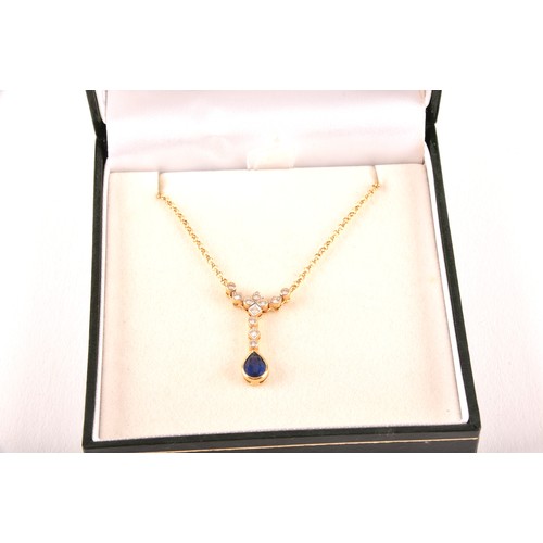 93 - An 18ct yellow gold sapphire and diamond necklace, featuring a pear cut sapphire with an approximate... 