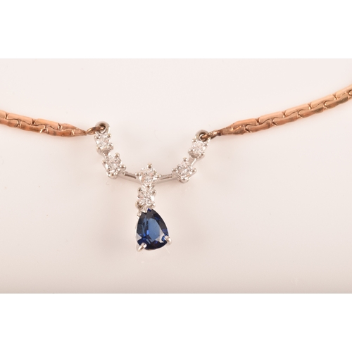 12 - A 14ct yellow gold sapphire and diamond necklace, featuring a pear cut sapphire with an approximate ... 