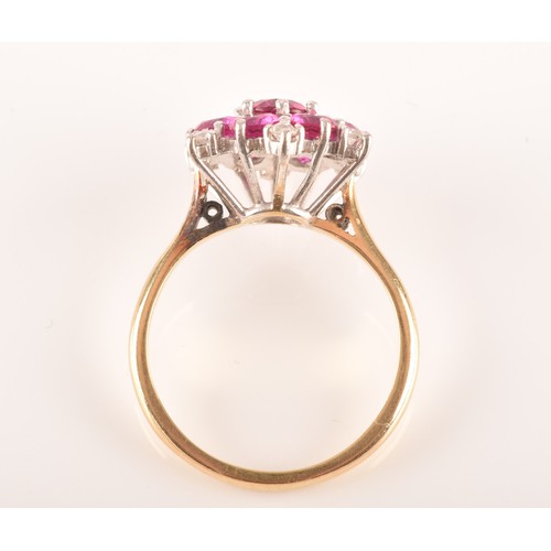 13 - A yellow and white metal synthetic ruby and diamond cluster ring, set to centre with a round ruby wi... 