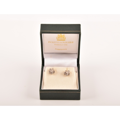 14 - A pair of 18ct white gold diamond set floral earrings, each set to centre with a brilliant cut diamo... 