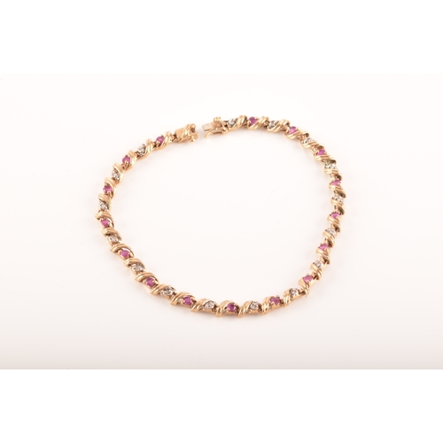 16 - A ruby and diamond 9ct yellow gold line bracelet, set with sixteen round rubies with a combined appr... 