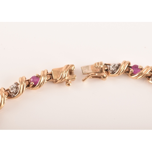 16 - A ruby and diamond 9ct yellow gold line bracelet, set with sixteen round rubies with a combined appr... 