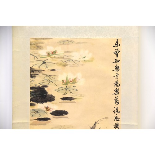 249 - A Chinese scroll depicting fish in a pond with lily pads, with Chinese character marks and two red s... 