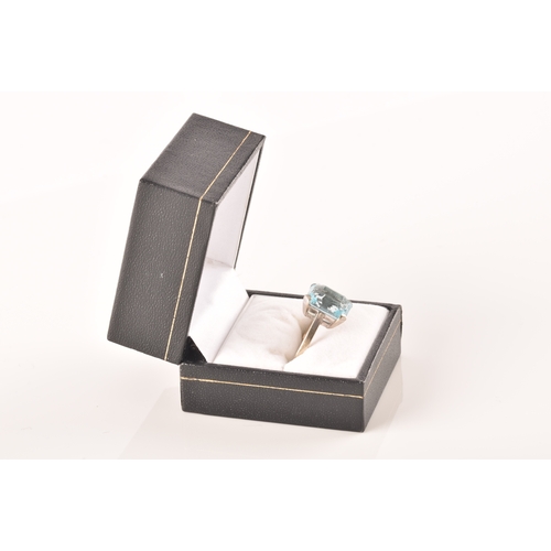 25 - A 9ct white gold and blue paste stone ring, set with a mixed rectangular-cut stone measuring approxi... 