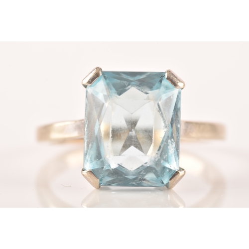 25 - A 9ct white gold and blue paste stone ring, set with a mixed rectangular-cut stone measuring approxi... 