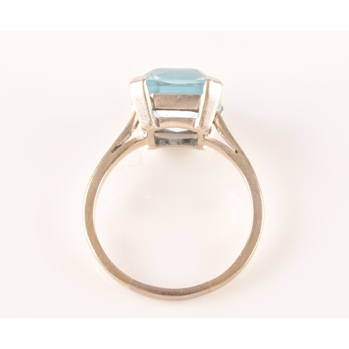 25 - A 9ct white gold and blue paste stone ring, set with a mixed rectangular-cut stone measuring approxi... 