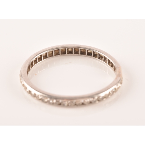 27 - A diamond and platinum eternity ring, channel-set with small eight-cut diamonds, band width 2.1 mm, ... 