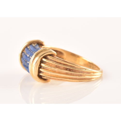 94 - An unusual Greek style yellow gold and lapis lazuli ring, set with ribbed lapis stone, with shaped r... 