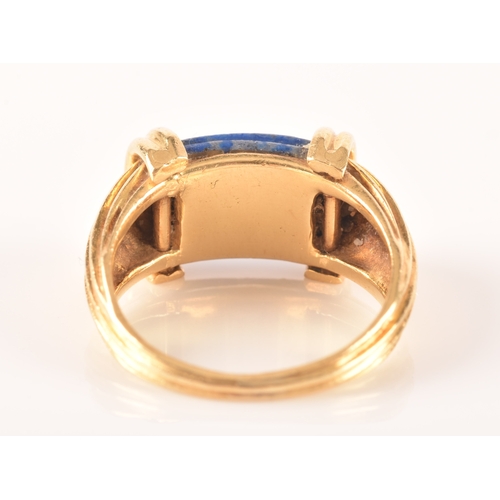 94 - An unusual Greek style yellow gold and lapis lazuli ring, set with ribbed lapis stone, with shaped r... 