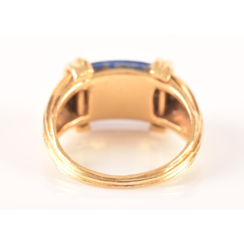 94 - An unusual Greek style yellow gold and lapis lazuli ring, set with ribbed lapis stone, with shaped r... 