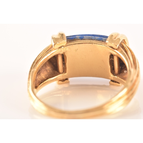 94 - An unusual Greek style yellow gold and lapis lazuli ring, set with ribbed lapis stone, with shaped r... 