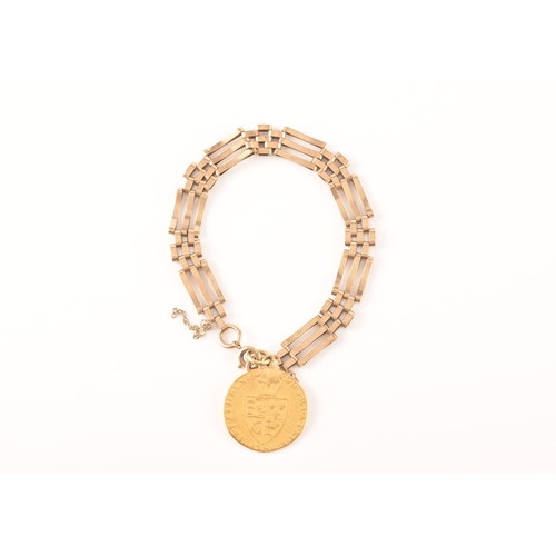 52 - A 9ct yellow gold gate-link bracelet, suspended with a George III spade guinea coin, the bracelet ma... 