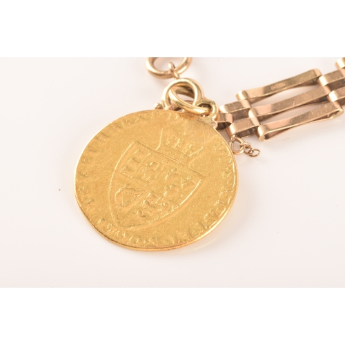 52 - A 9ct yellow gold gate-link bracelet, suspended with a George III spade guinea coin, the bracelet ma... 