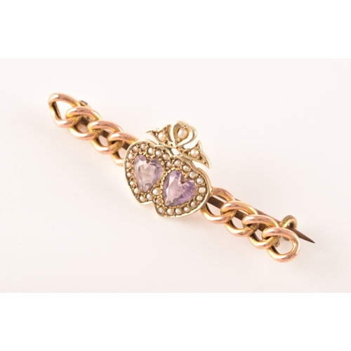 20 - A 9ct yellow gold and amethyst brooch, in a Celtic style, set with a large round-cut pale lilac amet... 