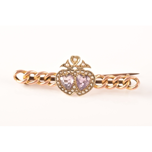 20 - A 9ct yellow gold and amethyst brooch, in a Celtic style, set with a large round-cut pale lilac amet... 