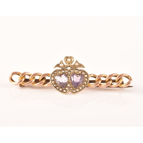 20 - A 9ct yellow gold and amethyst brooch, in a Celtic style, set with a large round-cut pale lilac amet... 