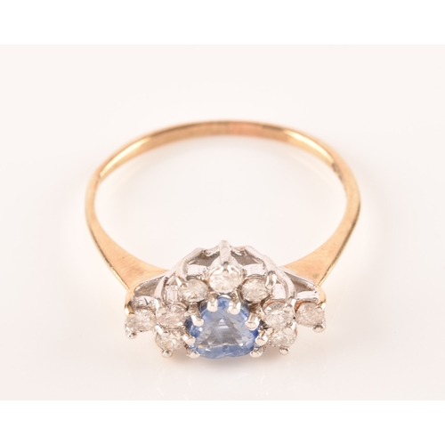 22 - A 9ct yellow gold, diamond, and sapphire ring, set with a mixed heart-cut sapphire, surrounded with ... 