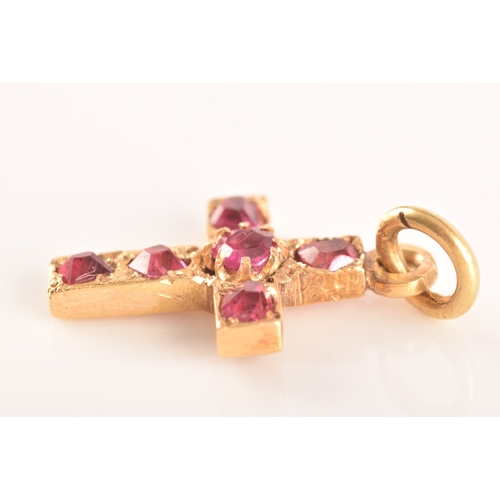 69 - A yellow metal and red stone clover bar brooch, set with two stones, unmarked, 1.7 cm long, together... 