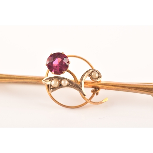 69 - A yellow metal and red stone clover bar brooch, set with two stones, unmarked, 1.7 cm long, together... 