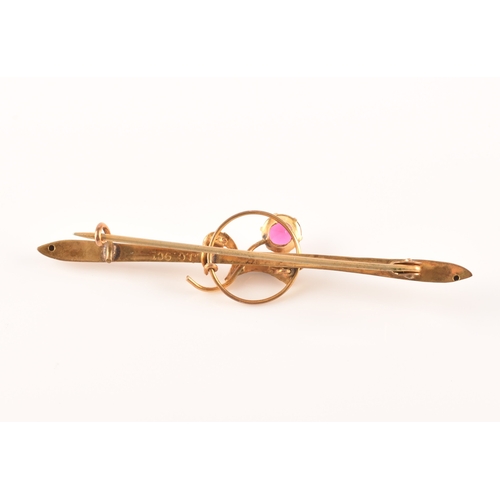 69 - A yellow metal and red stone clover bar brooch, set with two stones, unmarked, 1.7 cm long, together... 