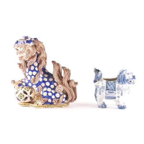 32 - Two Japanese porcelain dogs of foe, one blue and white measuring 15 x 13cm, the other red and blue m... 