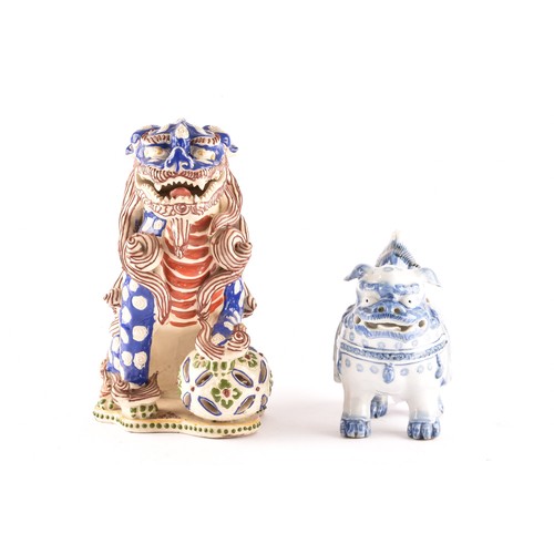 32 - Two Japanese porcelain dogs of foe, one blue and white measuring 15 x 13cm, the other red and blue m... 