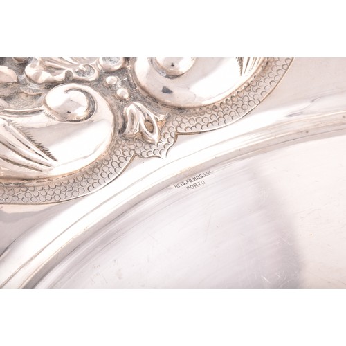 192 - A circular tray with heavily embossed border decoration, 36 x 36 cm, 22.1 ozt / 690 grams.