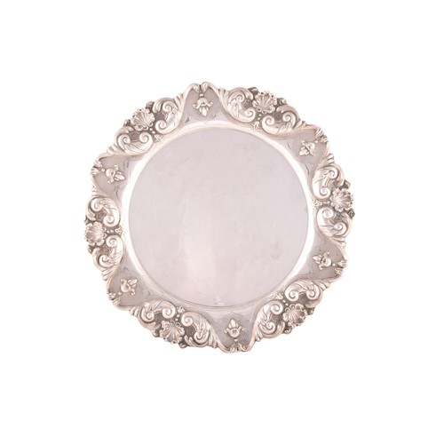 192 - A circular tray with heavily embossed border decoration, 36 x 36 cm, 22.1 ozt / 690 grams.