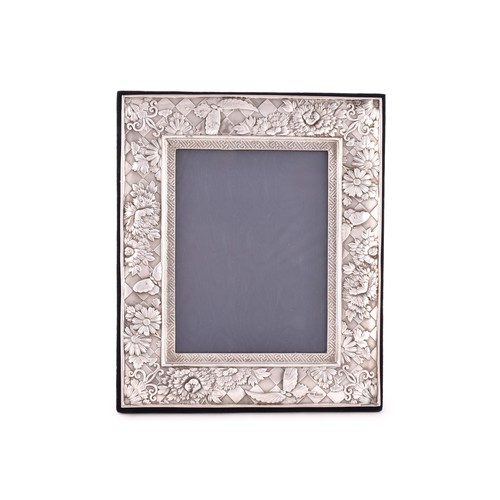 176 - An Elizabeth II silver photo frame, hallmarked London 1999 by GMG, heavily embossed flower and butte... 