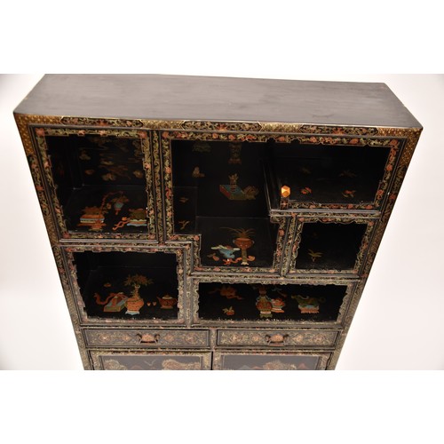 39 - A modern Japanese black lacquer display cabinet, gilt and polychrome decorated, the upper section wi... 