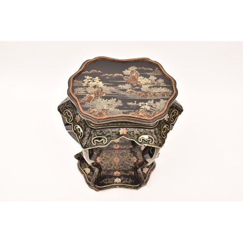 48 - A large Japanese black lacquer jardiniere stand, the top deorated with an extensive mountainous lans... 